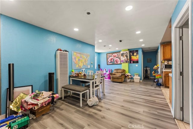 730 W 52nd Pl, Los Angeles, CA 90037 - recreation room featuring a heating unit, recessed lighting, and light wood-type flooring