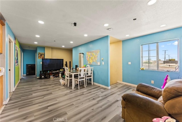 730 W 52nd Pl, Los Angeles, CA 90037 - living room with recessed lighting, light wood-style flooring, and a textured ceiling
