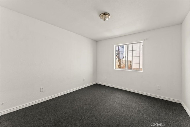730 W 52nd Pl, Los Angeles, CA 90037 - unfurnished room featuring baseboards and dark colored carpet