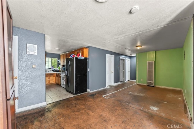 730 W 52nd Pl, Los Angeles, CA 90037 - unfurnished living room with a heating unit and a textured ceiling