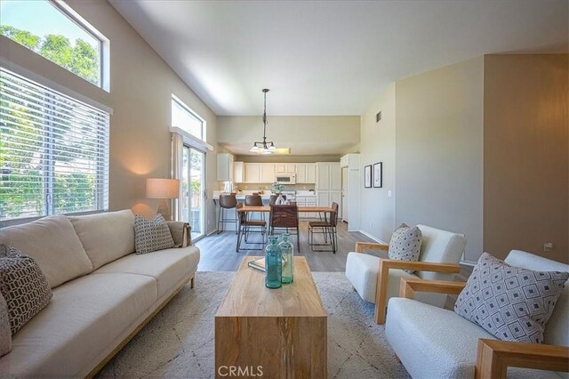 3087 Arbor Glen Ct, Corona, CA 92879 - living area with light wood-style flooring and a towering ceiling