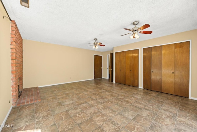 5240 Ramsdell Ave, La Crescenta, CA 91214 - unfurnished bedroom with stone finish flooring, a textured ceiling, multiple closets, and ceiling fan