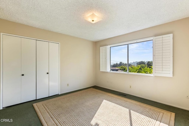 5240 Ramsdell Ave, La Crescenta, CA 91214 - unfurnished bedroom with carpet, a closet, and a textured ceiling