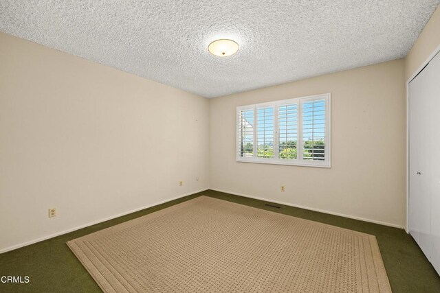 5240 Ramsdell Ave, La Crescenta, CA 91214 - unfurnished room with dark colored carpet and a textured ceiling