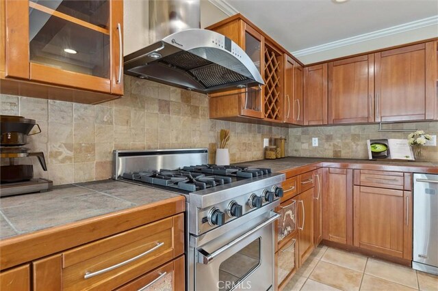 4441 Avocado Ave, Yorba Linda, CA 92886 - kitchen featuring appliances with stainless steel finishes, island range hood, ornamental molding, brown cabinets, and tile counters