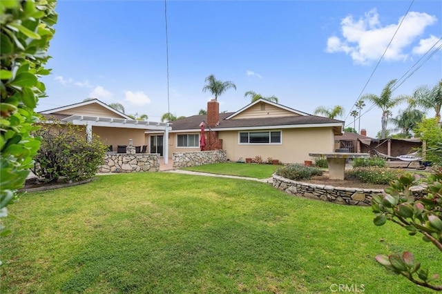 4441 Avocado Ave, Yorba Linda, CA 92886 - back of property with a lawn, stucco siding, and a chimney