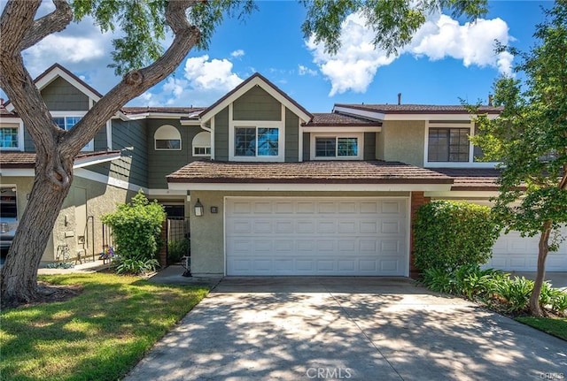 35 Havenwood Unit 83, Irvine, CA 92614 - view of property featuring stucco siding, concrete driveway, and a garage