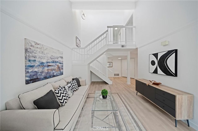 35 Havenwood Unit 83, Irvine, CA 92614 - living area with stairway, wood finished floors, and a towering ceiling
