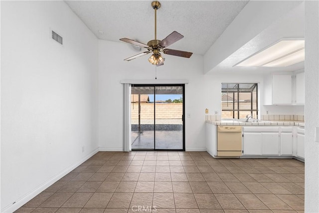 37756 45th, Palmdale, CA 93552 - kitchen with dishwasher, a ceiling fan, white cabinets, tile countertops, and light tile patterned floors