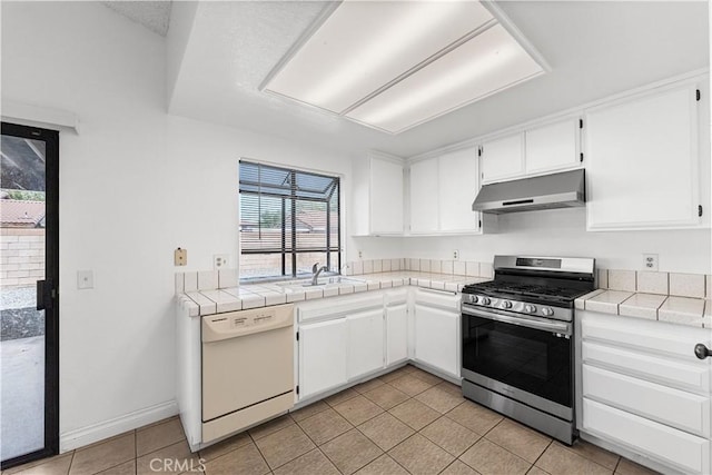 37756 45th, Palmdale, CA 93552 - kitchen featuring white dishwasher, stainless steel range with gas stovetop, under cabinet range hood, tile countertops, and light tile patterned floors