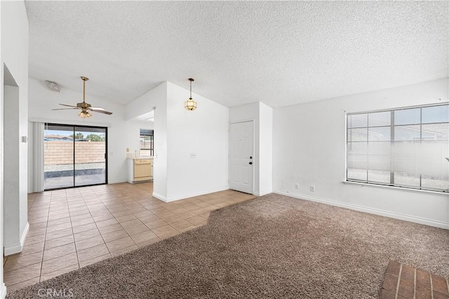 37756 45th, Palmdale, CA 93552 - unfurnished living room with ceiling fan, tile patterned floors, a textured ceiling, carpet floors, and lofted ceiling