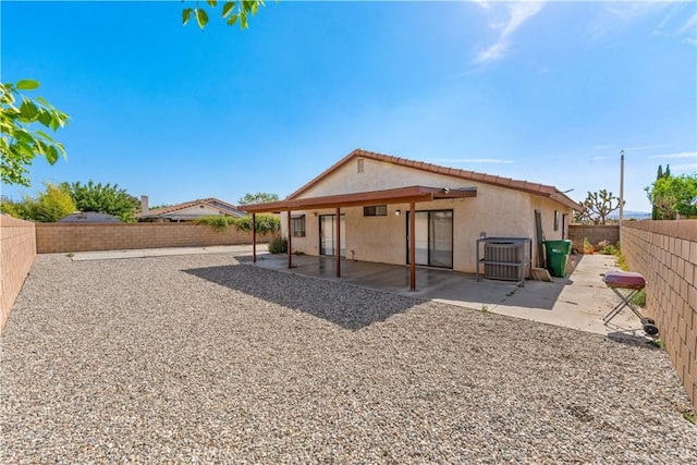 37756 45th, Palmdale, CA 93552 - rear view of property featuring stucco siding, a fenced backyard, a tile roof, and a patio area