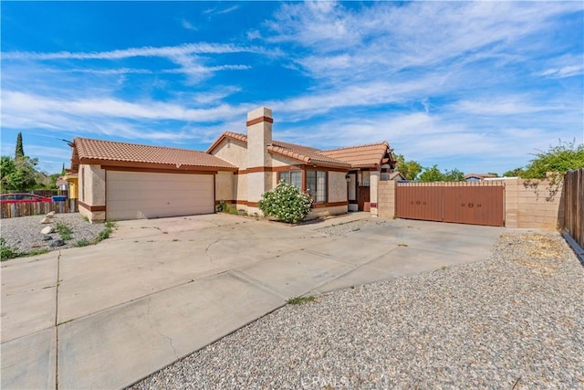 37756 45th, Palmdale, CA 93552 - view of front facade with a tile roof, stucco siding, a gate, a chimney, and driveway
