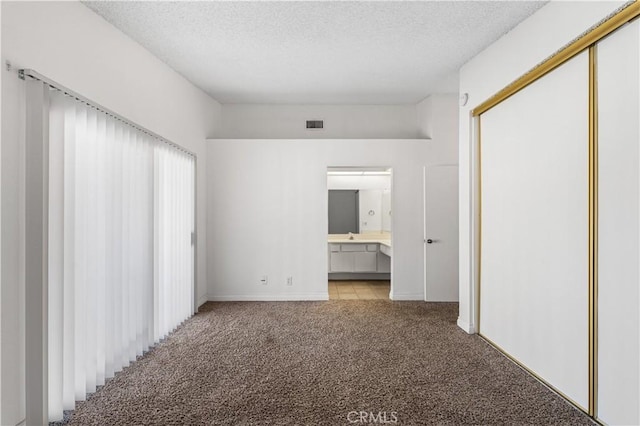 37756 45th, Palmdale, CA 93552 - unfurnished bedroom featuring light colored carpet, a textured ceiling, a closet, and ensuite bathroom