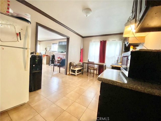 218 E 60th St, Los Angeles, CA 90003 - kitchen with freestanding refrigerator, crown molding, and light tile patterned floors