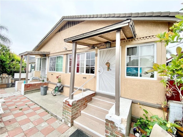 218 E 60th St, Los Angeles, CA 90003 - doorway to property with stucco siding and a patio