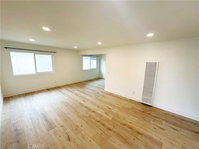 17412 Dairyview Cir Unit D, Huntington Beach, CA 92647 - spare room with a heating unit, light wood-style flooring, and recessed lighting
