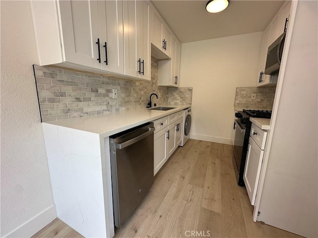 17412 Dairyview Cir Unit D, Huntington Beach, CA 92647 - kitchen with appliances with stainless steel finishes, washer / dryer, light countertops, and light wood-type flooring