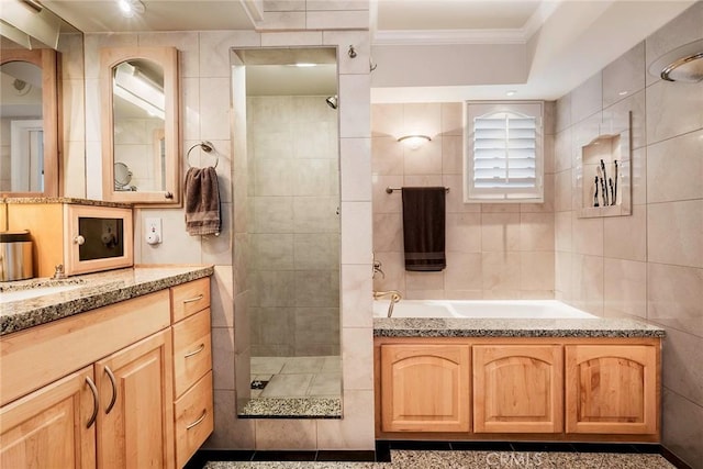3811 E Livingston Dr Unit 1, Long Beach, CA 90803 - bathroom with crown molding, a tile shower, a garden tub, vanity, and tile walls