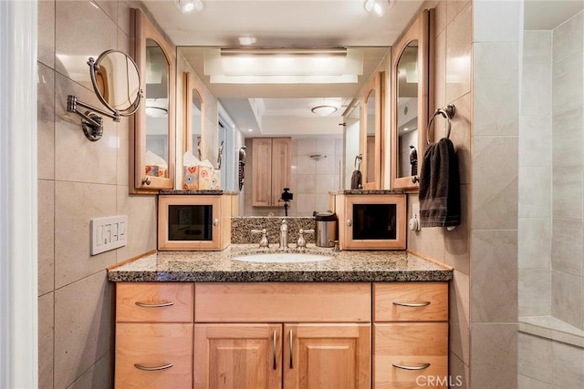 3811 E Livingston Dr Unit 1, Long Beach, CA 90803 - full bath featuring tile walls, vanity, and a raised ceiling