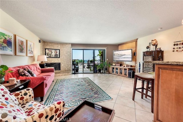 3811 E Livingston Dr Unit 1, Long Beach, CA 90803 - living area featuring a high end fireplace, light tile patterned floors, and a textured ceiling