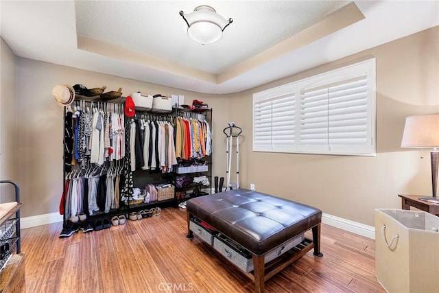 3811 E Livingston Dr Unit 1, Long Beach, CA 90803 - walk in closet featuring a tray ceiling and wood finished floors