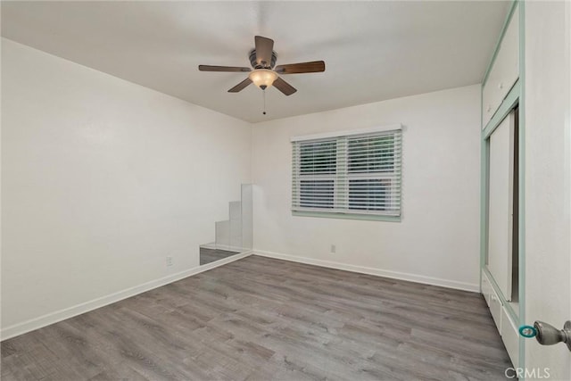 1220 Bidwell Ave, Chico, CA 95926 - unfurnished bedroom with wood finished floors, a closet, and a ceiling fan