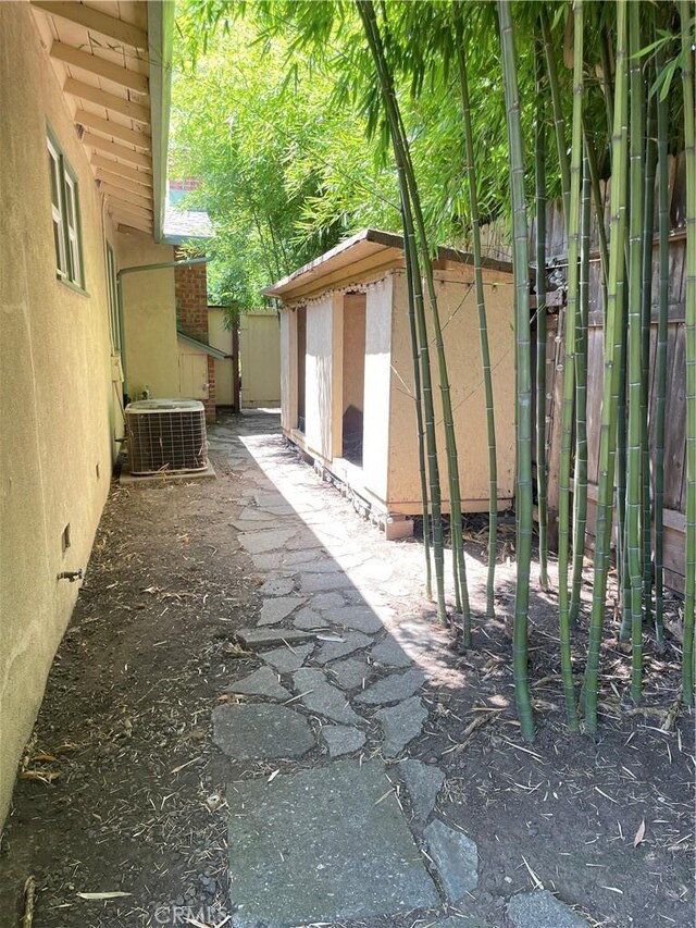1220 Bidwell Ave, Chico, CA 95926 - view of side of home featuring a central AC unit and a shed