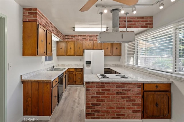 1220 Bidwell Ave, Chico, CA 95926 - kitchen with white appliances, brown cabinets, and light countertops