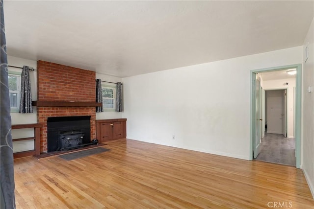 1220 Bidwell Ave, Chico, CA 95926 - unfurnished living room with light wood finished floors and a fireplace