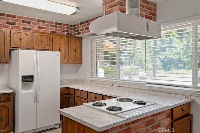 1220 Bidwell Ave, Chico, CA 95926 - kitchen featuring white appliances, island exhaust hood, brown cabinets, and light countertops