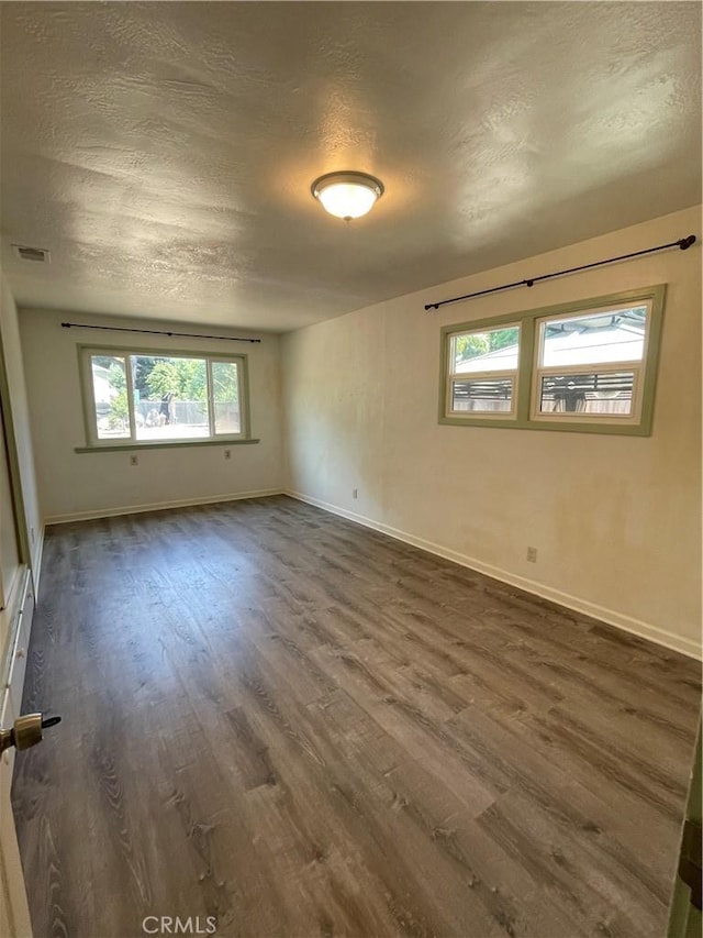 1220 Bidwell Ave, Chico, CA 95926 - empty room featuring dark wood-style floors and a textured ceiling