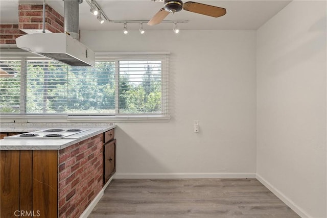 1220 Bidwell Ave, Chico, CA 95926 - kitchen featuring rail lighting, white electric cooktop, light countertops, a ceiling fan, and light wood-type flooring