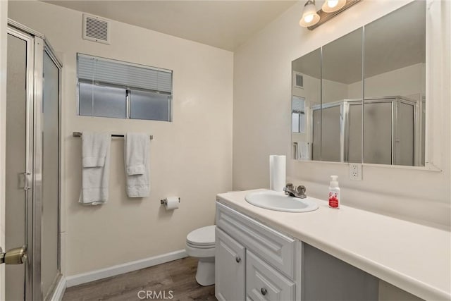 1220 Bidwell Ave, Chico, CA 95926 - full bath featuring vanity, a stall shower, and wood finished floors