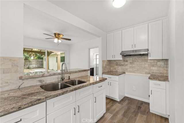 9912 Marshall St, El Monte, CA 91731 - kitchen with under cabinet range hood, light stone countertops, and backsplash