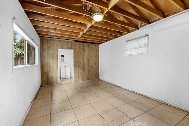 9912 Marshall St, El Monte, CA 91731 - basement featuring light tile patterned flooring and wooden walls