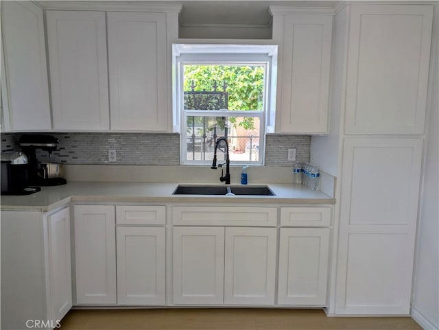 10051 Orchard St, Bloomington, CA 92316 - kitchen with light countertops, white cabinetry, and backsplash