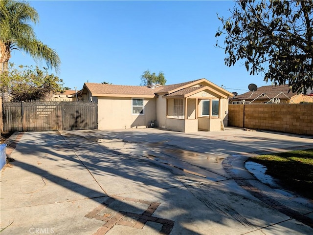 10051 Orchard St, Bloomington, CA 92316 - back of house with stucco siding and driveway