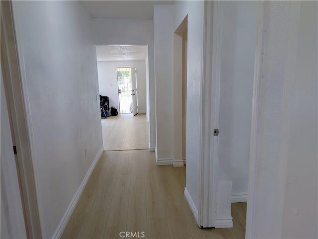 10051 Orchard St, Bloomington, CA 92316 - hallway featuring light wood-type flooring and baseboards