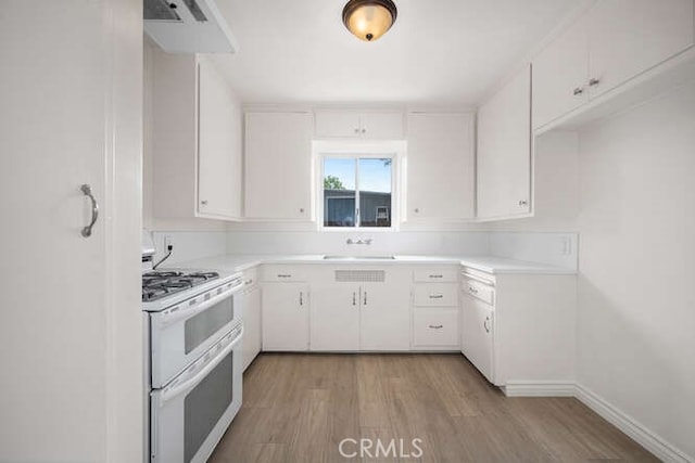 338 Prospect Ave, Long Beach, CA 90814 - kitchen featuring white appliances, light countertops, white cabinets, and light wood-type flooring
