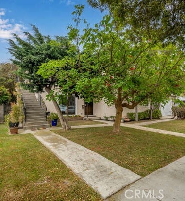 338 Prospect Ave, Long Beach, CA 90814 - view of property hidden behind natural elements with a front lawn and stairs