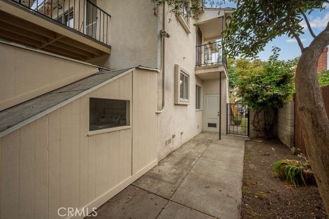 338 Prospect Ave, Long Beach, CA 90814 - view of home's exterior with a balcony, a gate, and stucco siding