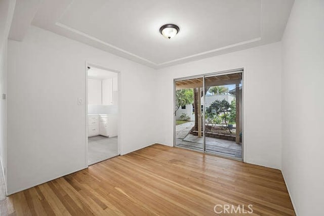 338 Prospect Ave, Long Beach, CA 90814 - unfurnished room with wood finished floors and a tray ceiling