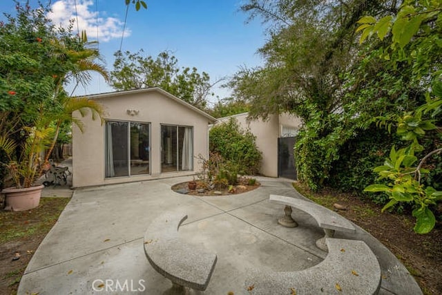 338 Prospect Ave, Long Beach, CA 90814 - back of property featuring stucco siding and a patio area