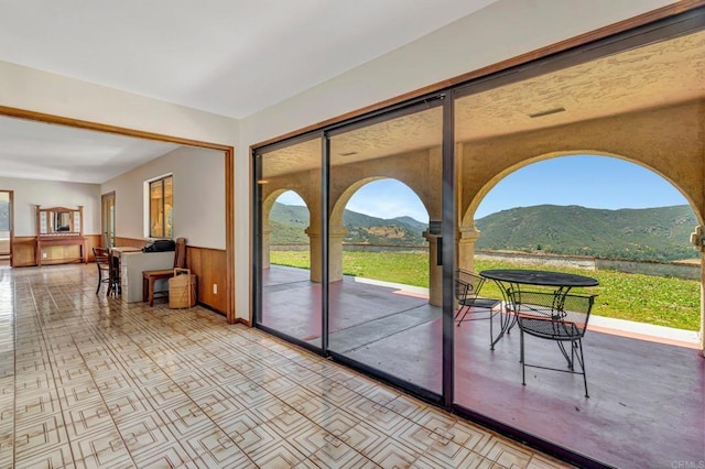 2702 Country Club Dr, Escondido, CA 92029 - doorway to outside with a mountain view, plenty of natural light, and wainscoting