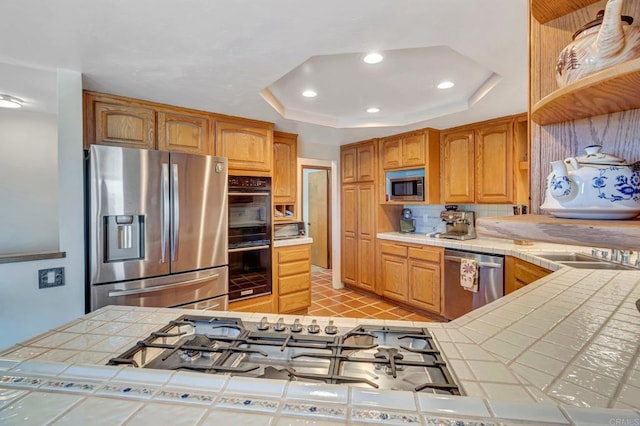 2702 Country Club Dr, Escondido, CA 92029 - kitchen featuring stainless steel appliances, tile countertops, a raised ceiling, recessed lighting, and decorative backsplash