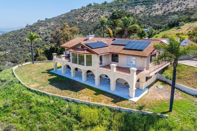 2702 Country Club Dr, Escondido, CA 92029 - rear view of house with a balcony, solar panels, a patio, a lawn, and a mountain view