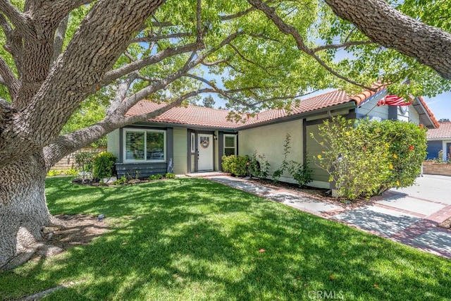 27817 Wakefield Rd, Castaic, CA 91384 - ranch-style house with a tile roof, a front yard, and stucco siding