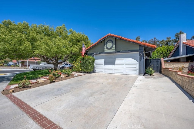 27817 Wakefield Rd, Castaic, CA 91384 - view of front of property with concrete driveway, a tiled roof, and an attached garage