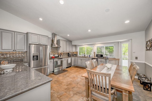 27817 Wakefield Rd, Castaic, CA 91384 - kitchen with appliances with stainless steel finishes, gray cabinets, vaulted ceiling, decorative backsplash, and healthy amount of natural light